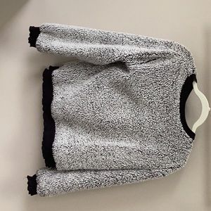 Grey fluffy sweater with black details